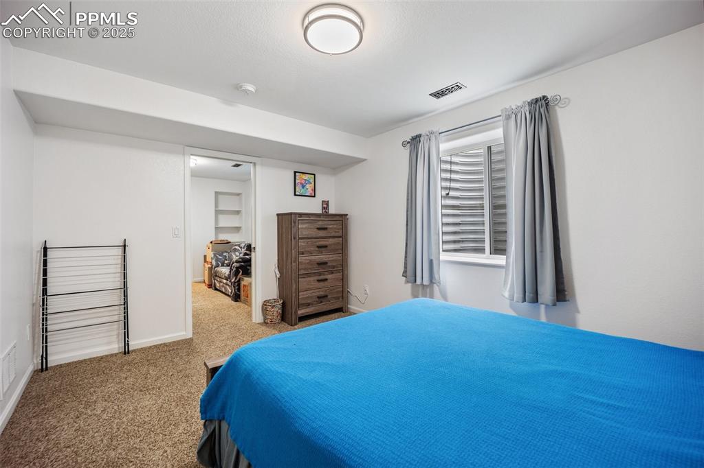 Image 41 of 50: Carpeted bedroom with baseboards