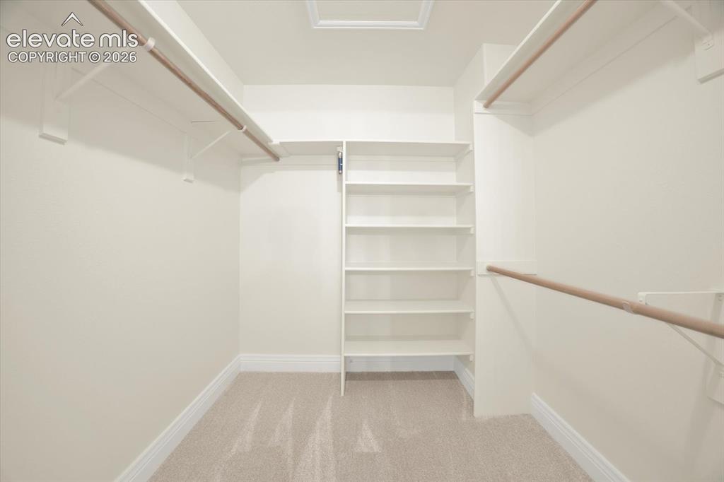 Image 22 of 46: Primary walk-in closet.