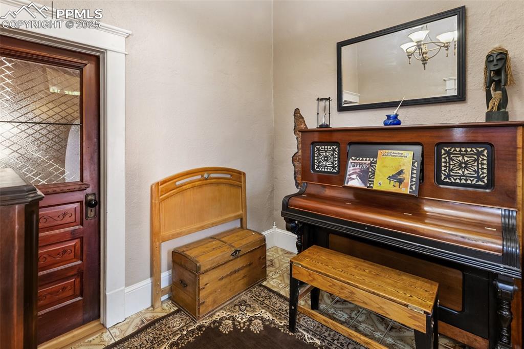 Image 12 of 43: another view of the Foyer or Piano Room. You can the window in the door int