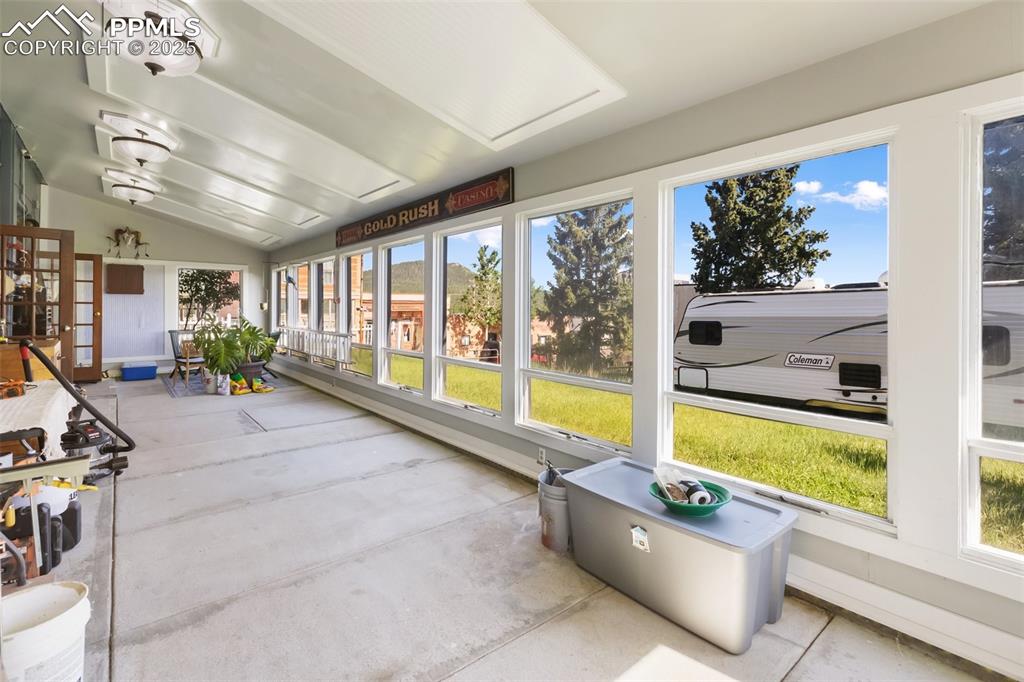 Image 26 of 43: Solarium, looking west to east, floor in concrete to hold heat, notice that
