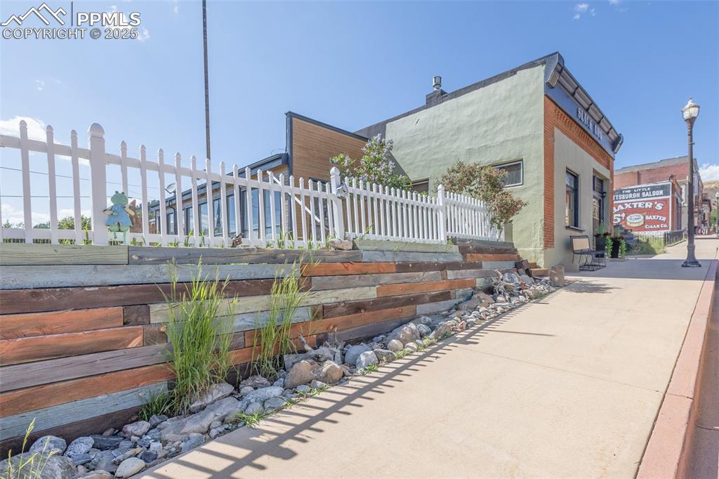 Image 3 of 43: this view is from the south looking north shows retaining wall and the fron