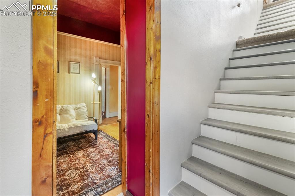 Image 39 of 43: staircase to the upstairs, either from the second downstairs bedroom or fro