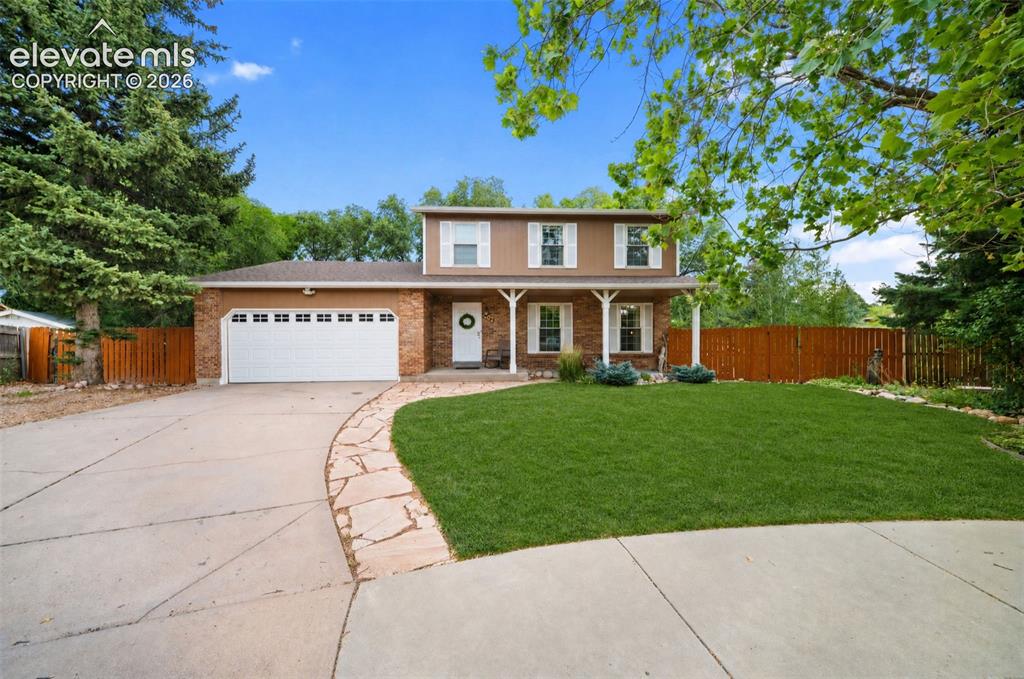 Image 1 of 44: Two-story residence featuring a brick facade, white shuttered windows, and