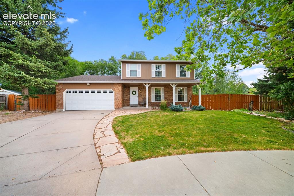Image 1 of 42: Two-story residence featuring a brick and siding exterior, a two-car garage