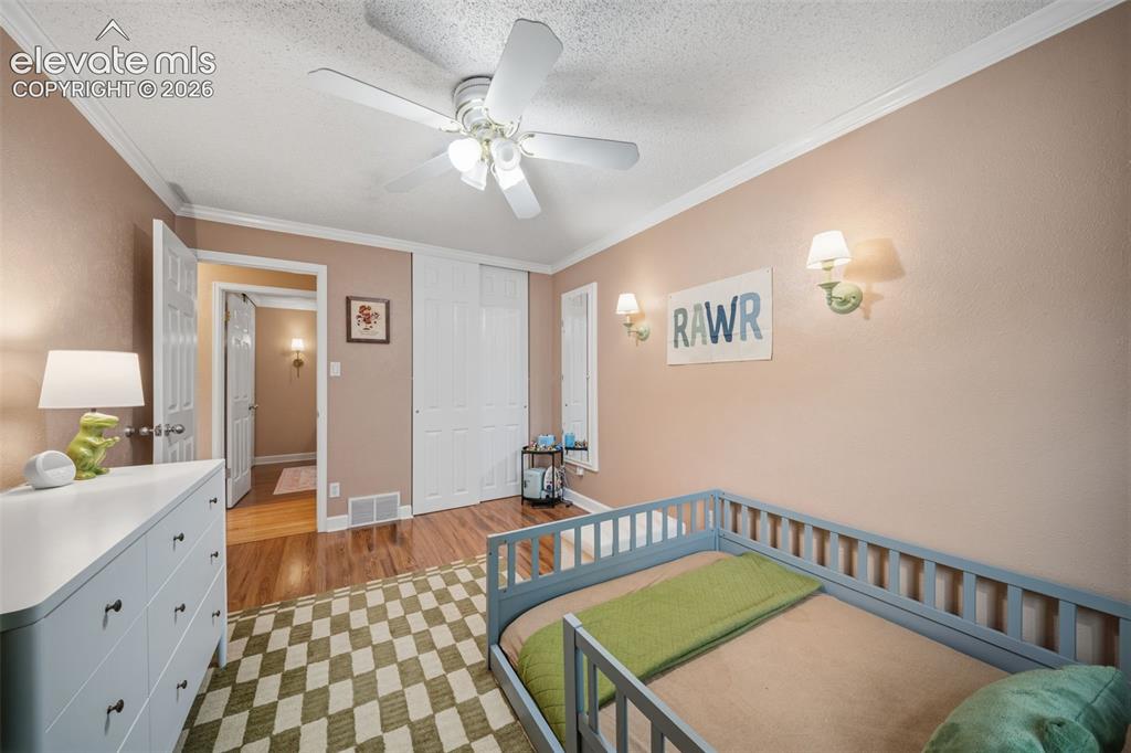 Image 24 of 42: Bedroom featuring wood-finish flooring, a ceiling fan with integrated light