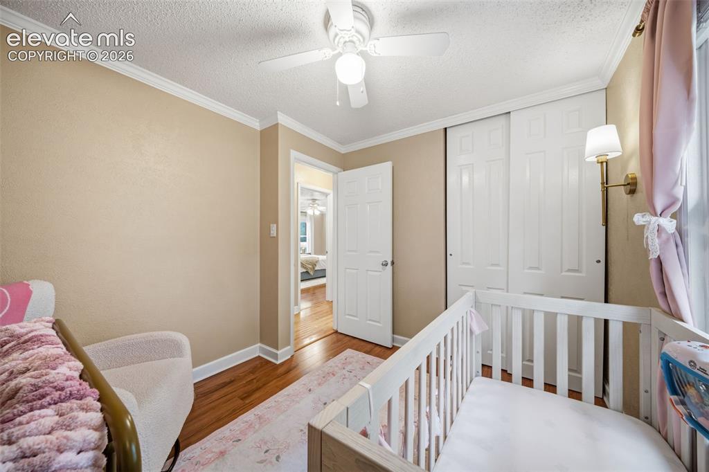 Image 27 of 42: Interior room featuring wood-finish flooring, a ceiling fan with integrated
