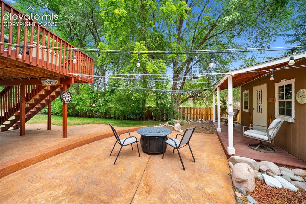 Image 30 of 42: Expansive outdoor living area featuring a two-story wood deck with railing,