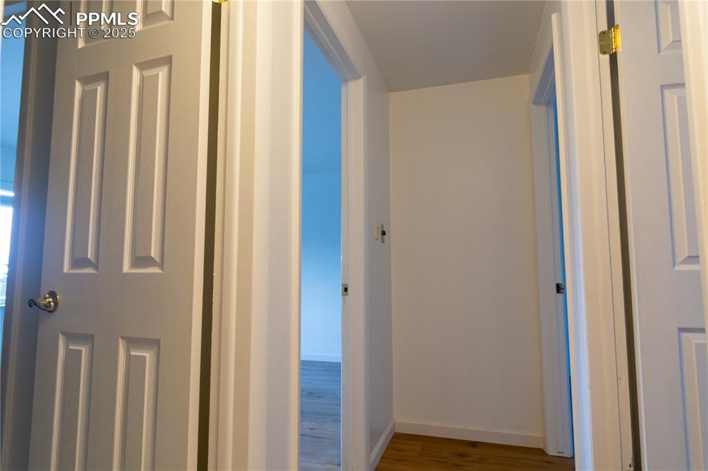 Image 16 of 47: Hallway with wood finished floors and a water view