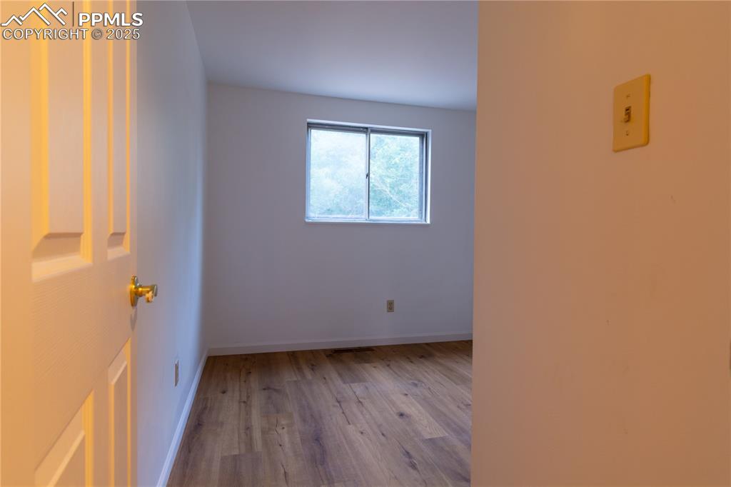Image 17 of 47: Unfurnished room with wood finished floors and baseboards