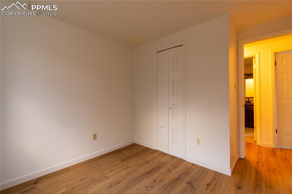 Image 18 of 47: Unfurnished bedroom with a closet and light wood-style floors