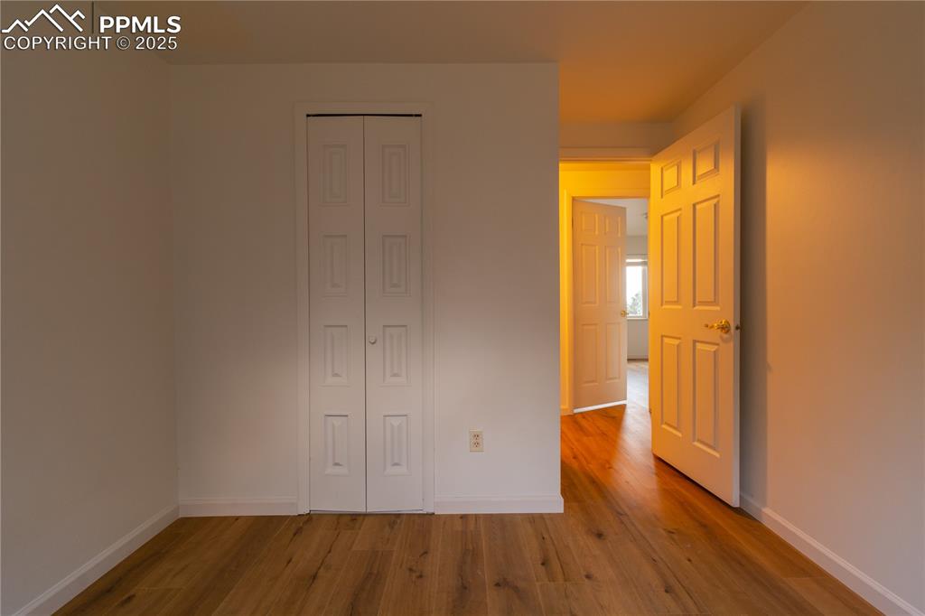 Image 19 of 47: Unfurnished bedroom with wood finished floors and a closet