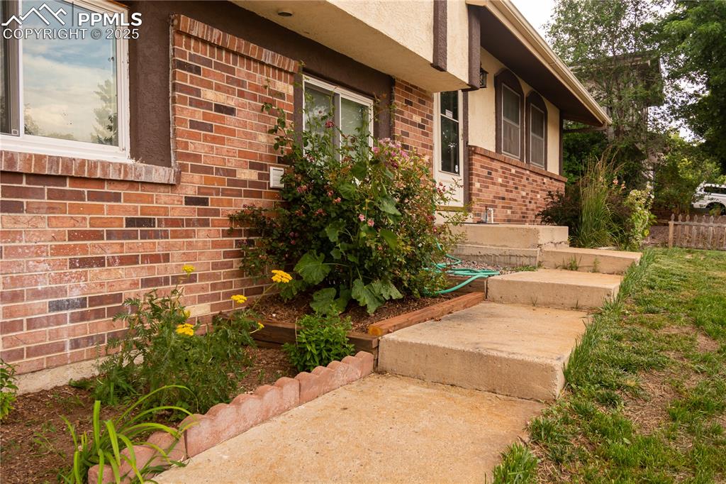 Image 2 of 47: View of exterior entry with brick siding