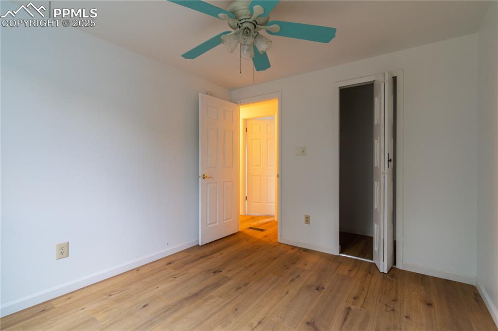 Image 22 of 47: Unfurnished bedroom featuring light wood-style flooring and a ceiling fan