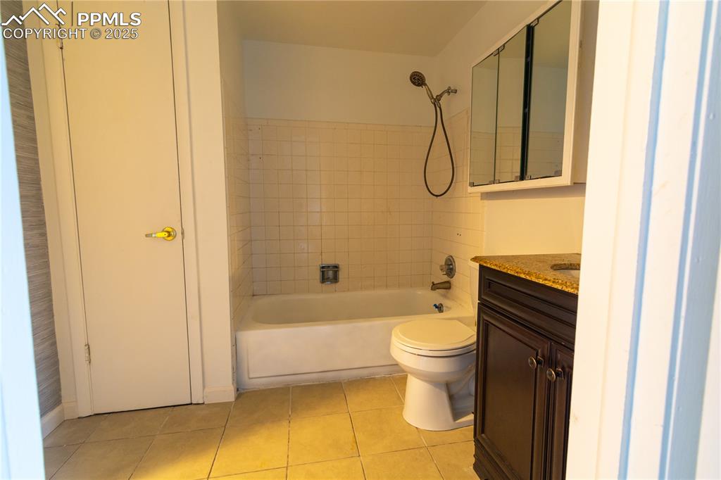 Image 26 of 47: Full bathroom featuring tile patterned floors, vanity, and shower / bath co