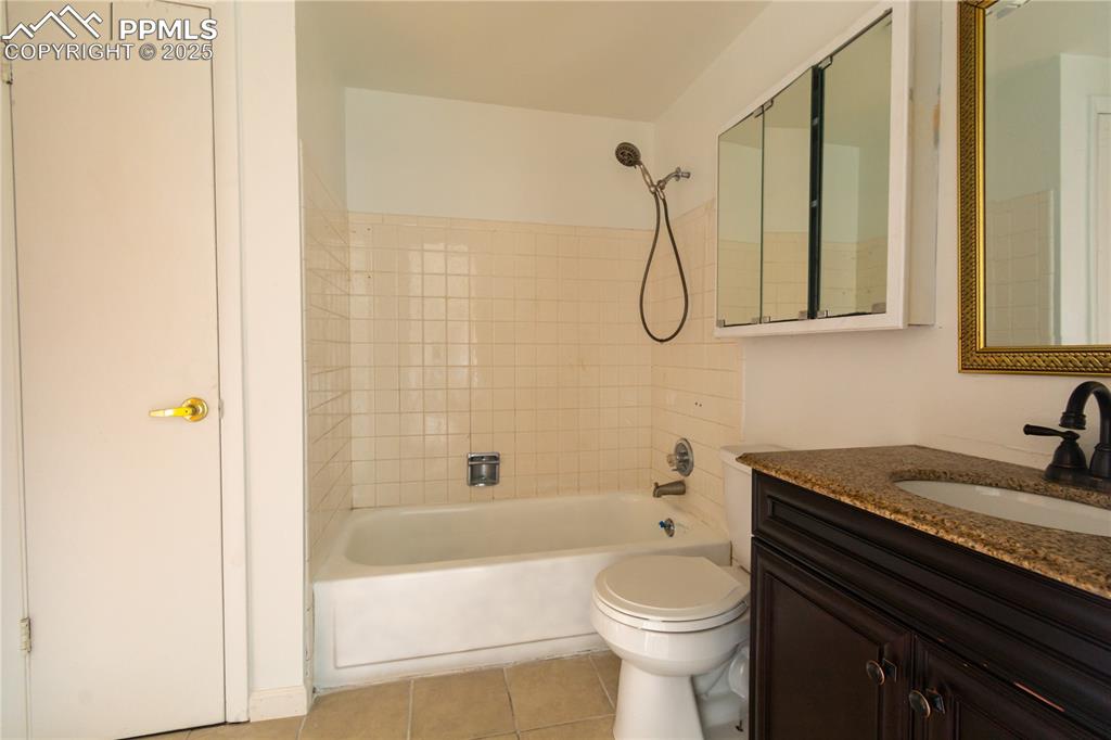 Image 29 of 47: Full bathroom with vanity, tile patterned floors, and shower / bath combina