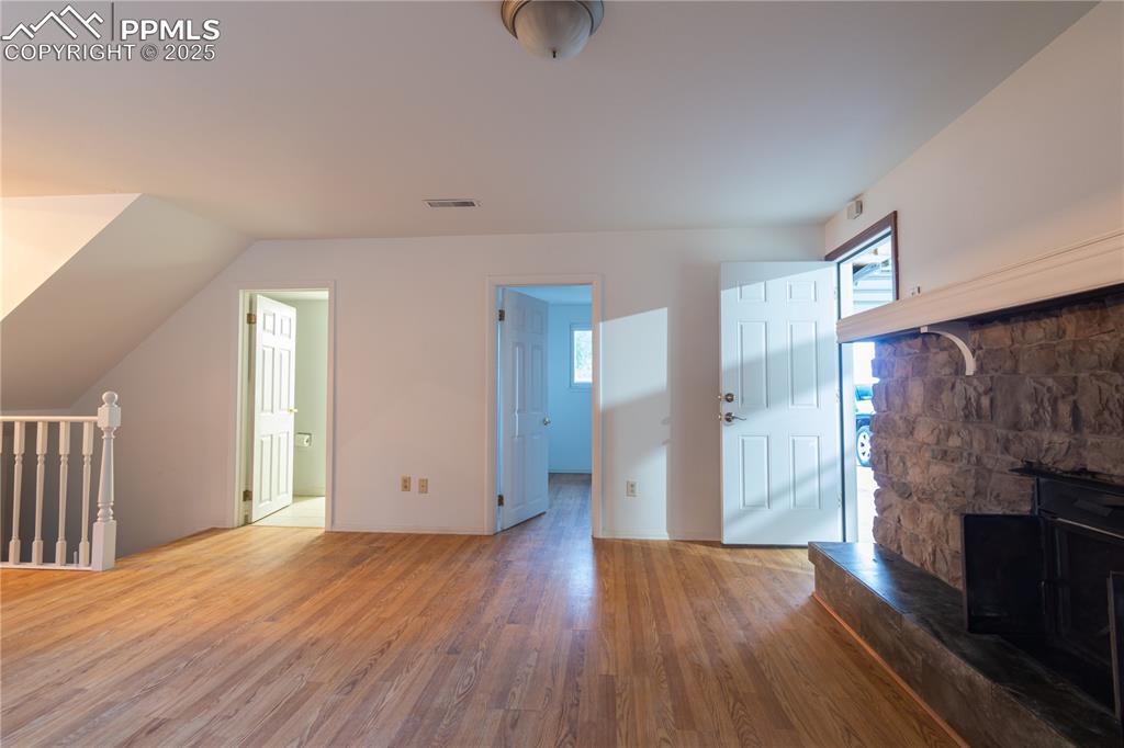 Image 31 of 47: Unfurnished living room featuring wood finished floors