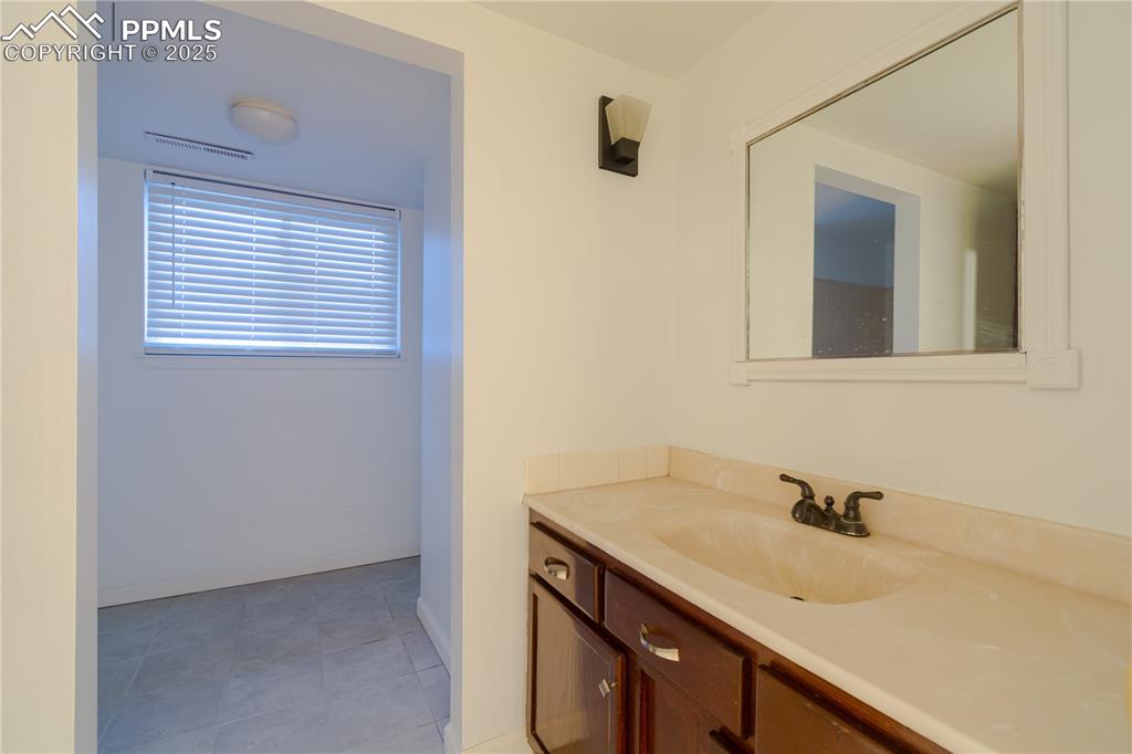 Image 39 of 47: Bathroom featuring vanity and tile patterned floors