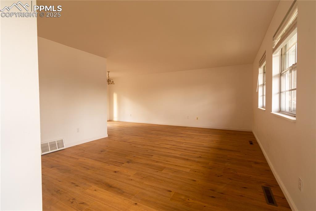 Image 4 of 47: Spare room with hardwood / wood-style floors