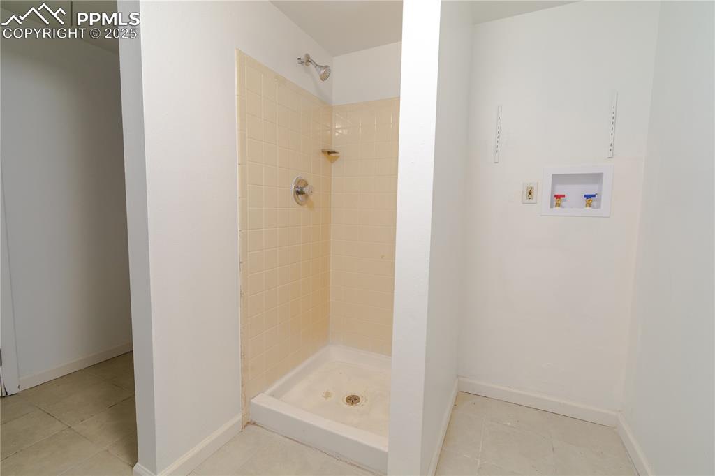 Image 41 of 47: Full bath featuring a shower stall and tile patterned flooring
