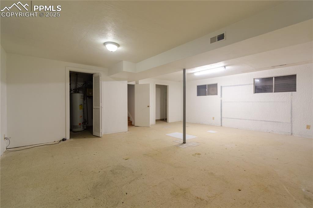 Image 43 of 47: Finished basement featuring gas water heater