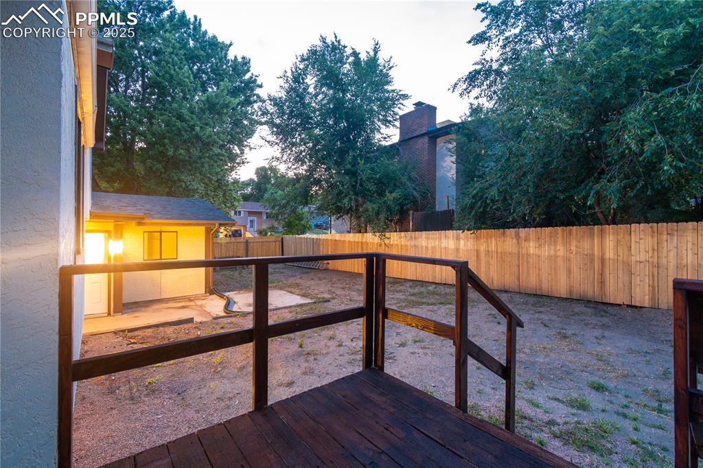 Image 45 of 47: Wooden terrace featuring a fenced backyard
