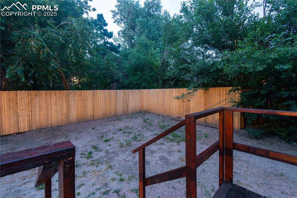 Image 46 of 47: View of fenced backyard