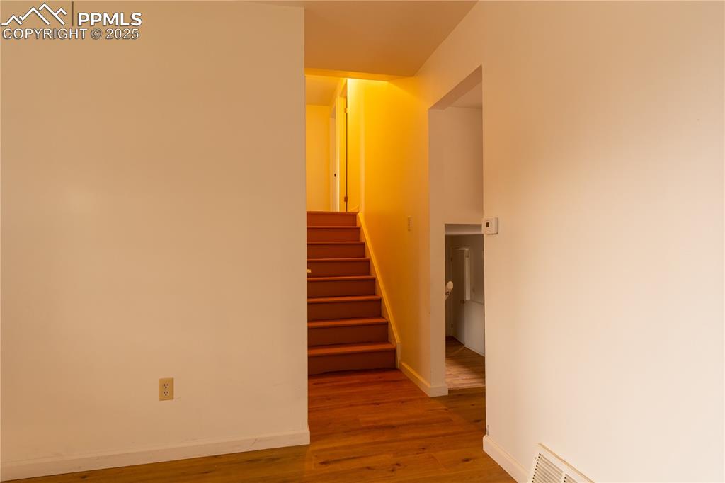 Image 7 of 47: Stairway featuring wood finished floors and baseboards