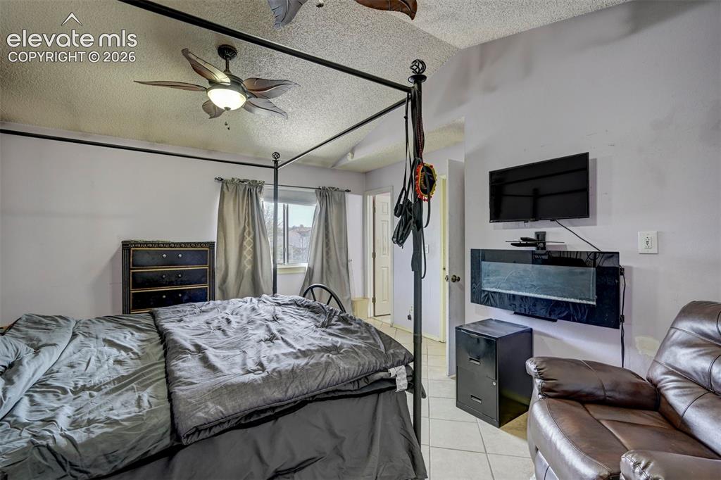 Image 23 of 43: Spacious room featuring a ceiling fan with integrated lighting, a window wi