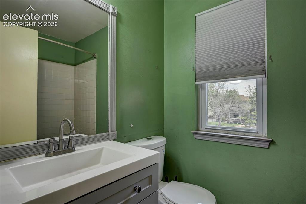 Image 28 of 43: Bathroom featuring a vanity with an integrated sink, brushed nickel faucet,