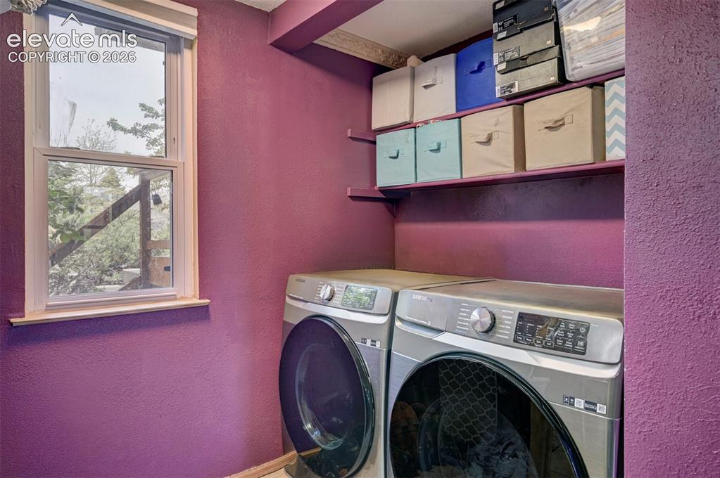 Image 31 of 43: Functional utility space featuring a double-hung window, built-in shelving,