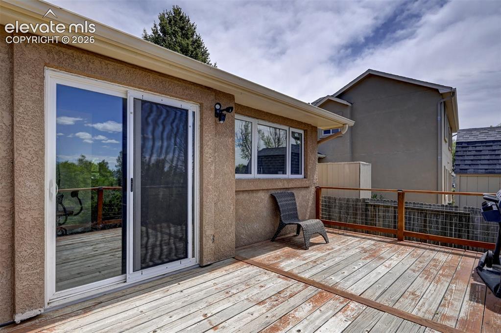 Image 33 of 43: Expansive outdoor deck featuring wood flooring and a wooden railing
