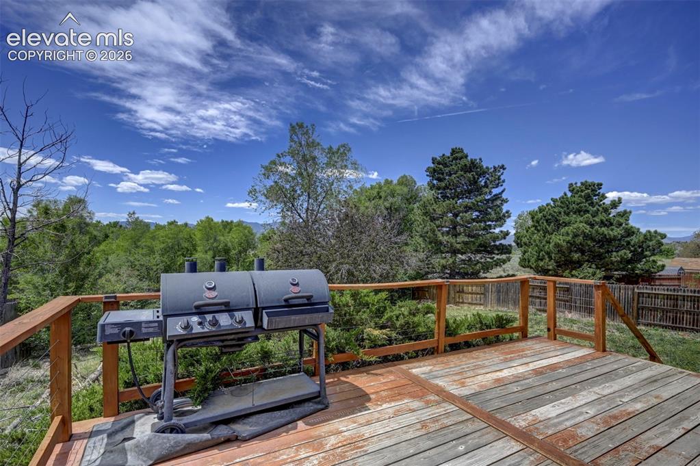 Image 34 of 43: Spacious outdoor wood deck with a natural finish, featuring wood railings