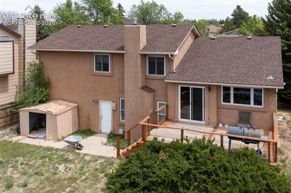 Image 35 of 43: Stucco exterior residence with a multi-level composite shingle roof