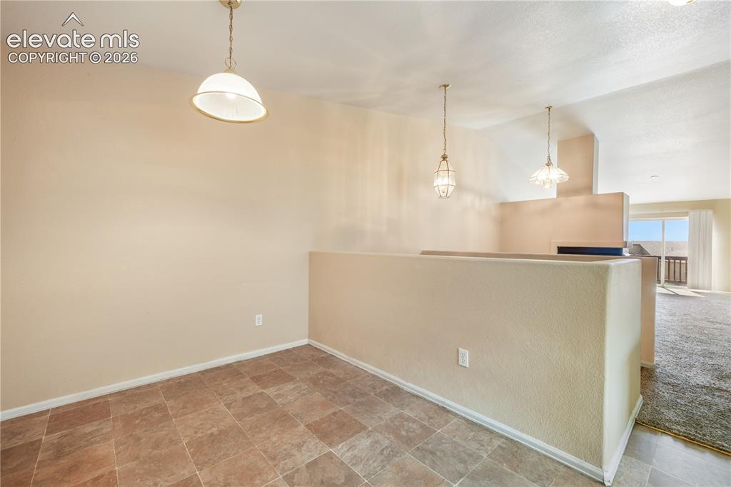Image 15 of 50: Kitchen eat in area and access to the garage