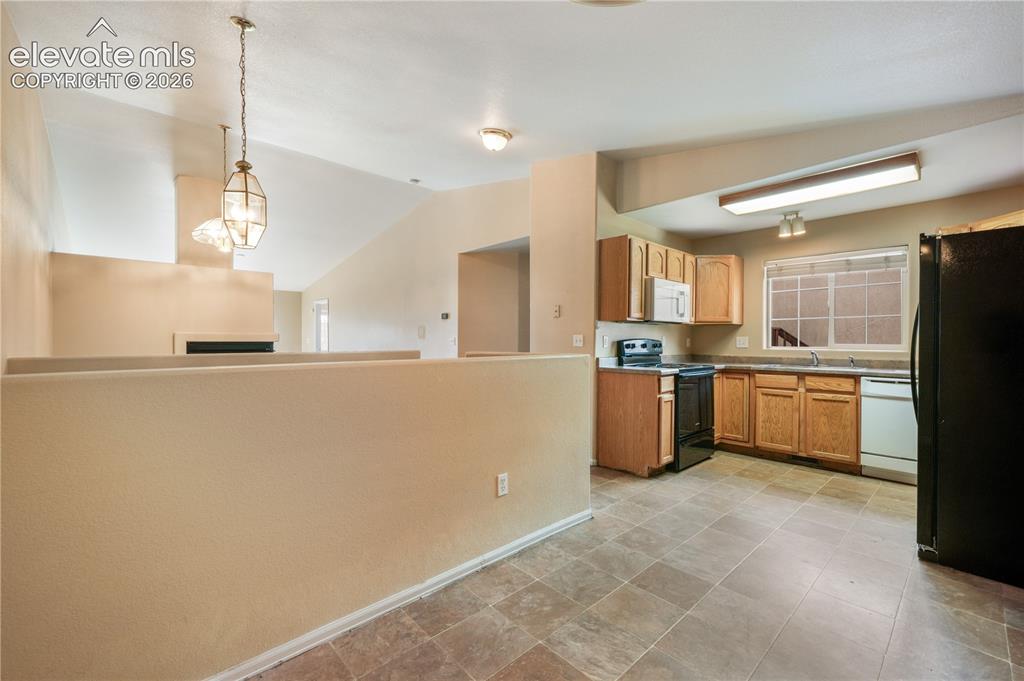 Image 16 of 50: Kitchen eat in area and access to the garage