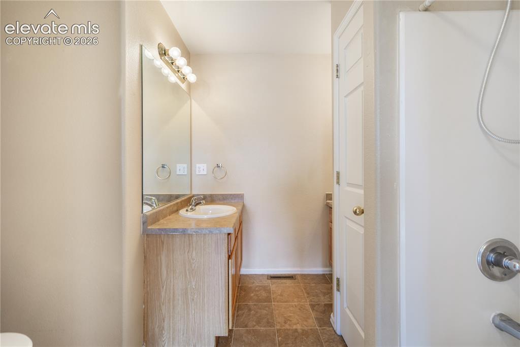 Image 32 of 50: Main level primary ensuite bathroom 2 vanities, 2 separate showers