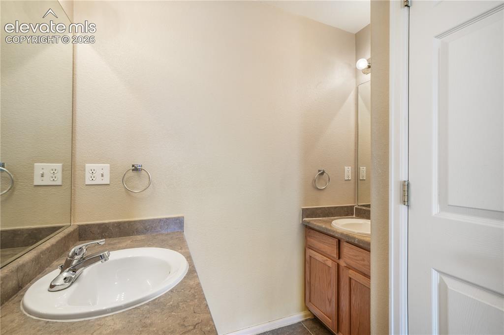 Image 33 of 50: Main level primary ensuite bathroom 2 vanities, 2 separate showers