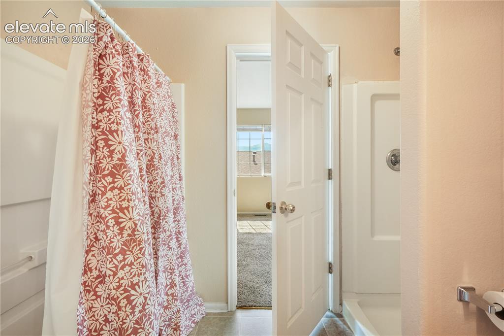 Image 34 of 50: Main level primary ensuite bathroom 2 vanities, 2 separate showers