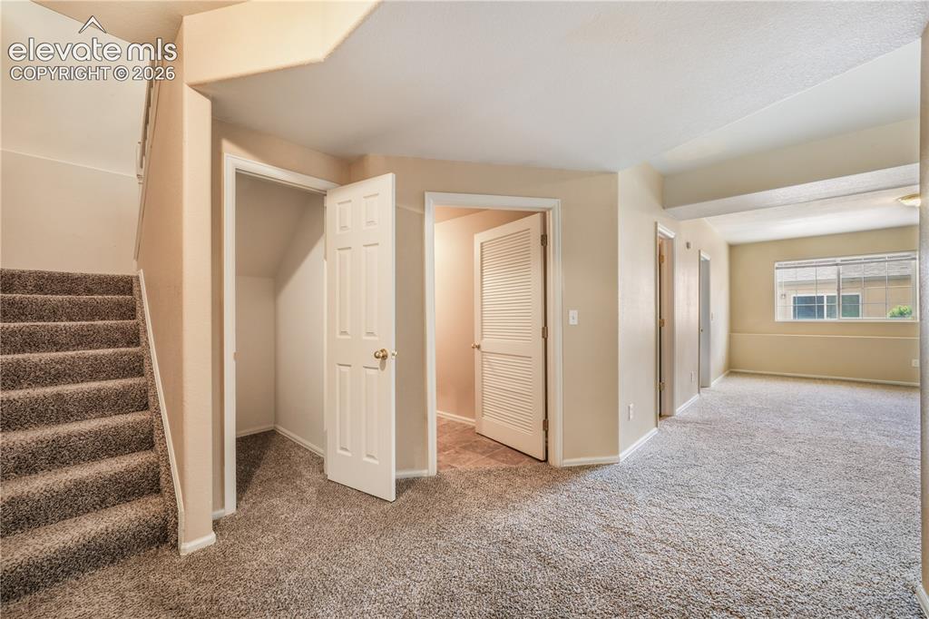 Image 35 of 50: Basement view showing one of two storage areas, laundry room and family roo