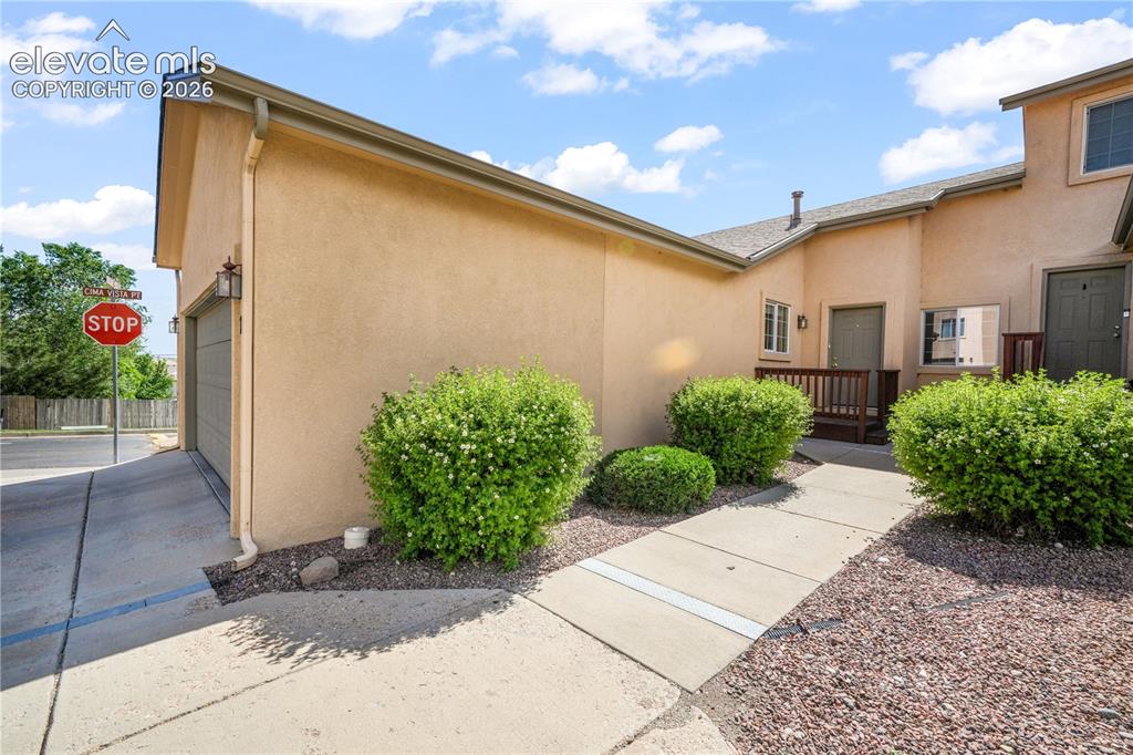 Image 6 of 50: Front entry to home showing garage