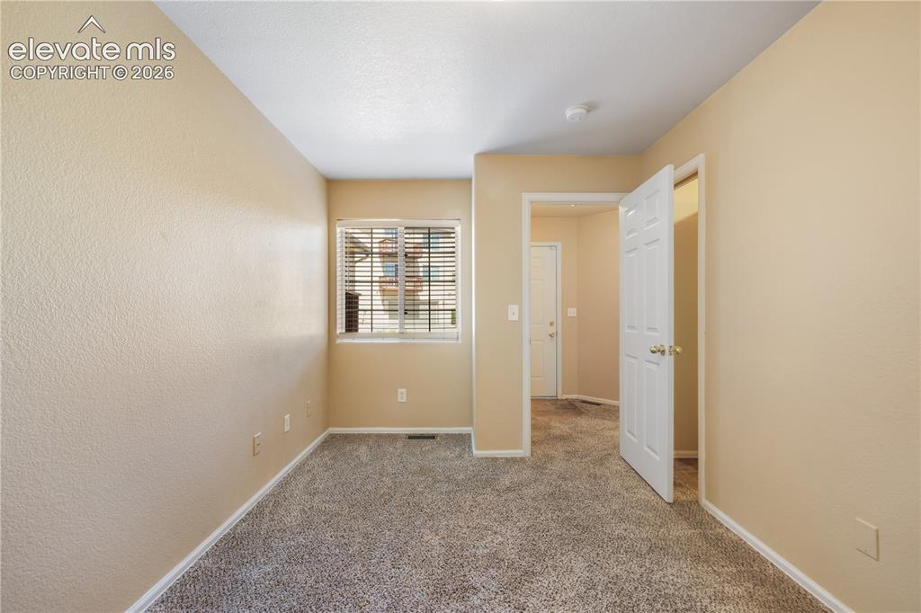 Image 8 of 50: First bedroom, main floor at front of home with connecting access to the 3/