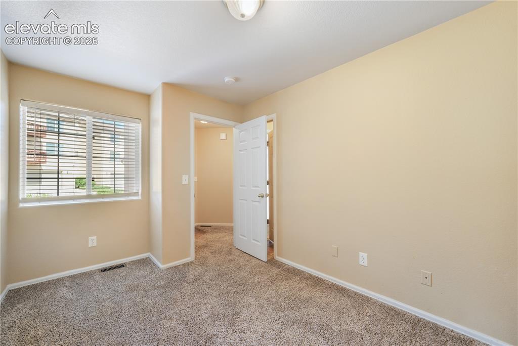 Image 9 of 50: First bedroom, main floor at front of home with connecting access to the 3/