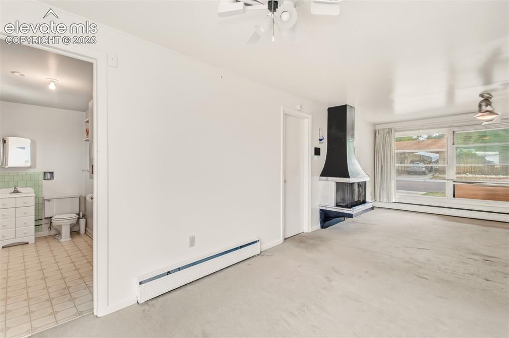 Image 6 of 25: Dining area with walk out looking to the living room and half bathroom/Util