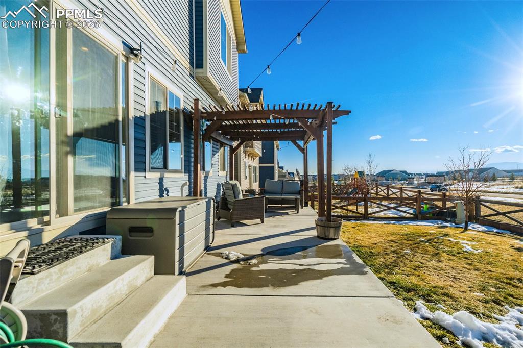Image 35 of 43: Extended concrete patio with a Pergola. 