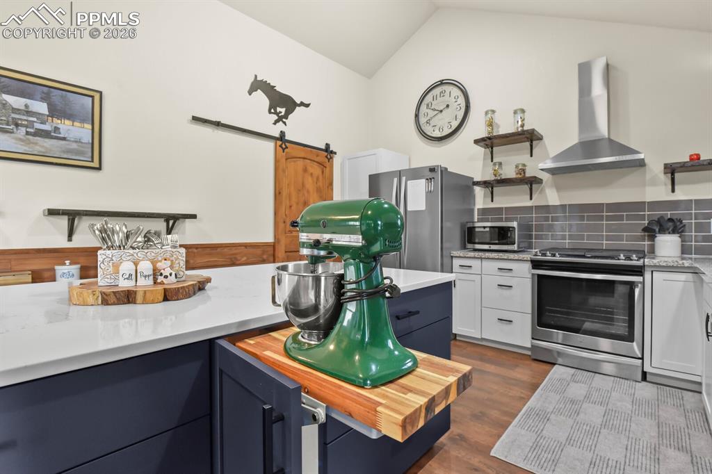 Image 11 of 41: Kitchen with open shelves, a barn door, stainless steel Stainless Steel Gas