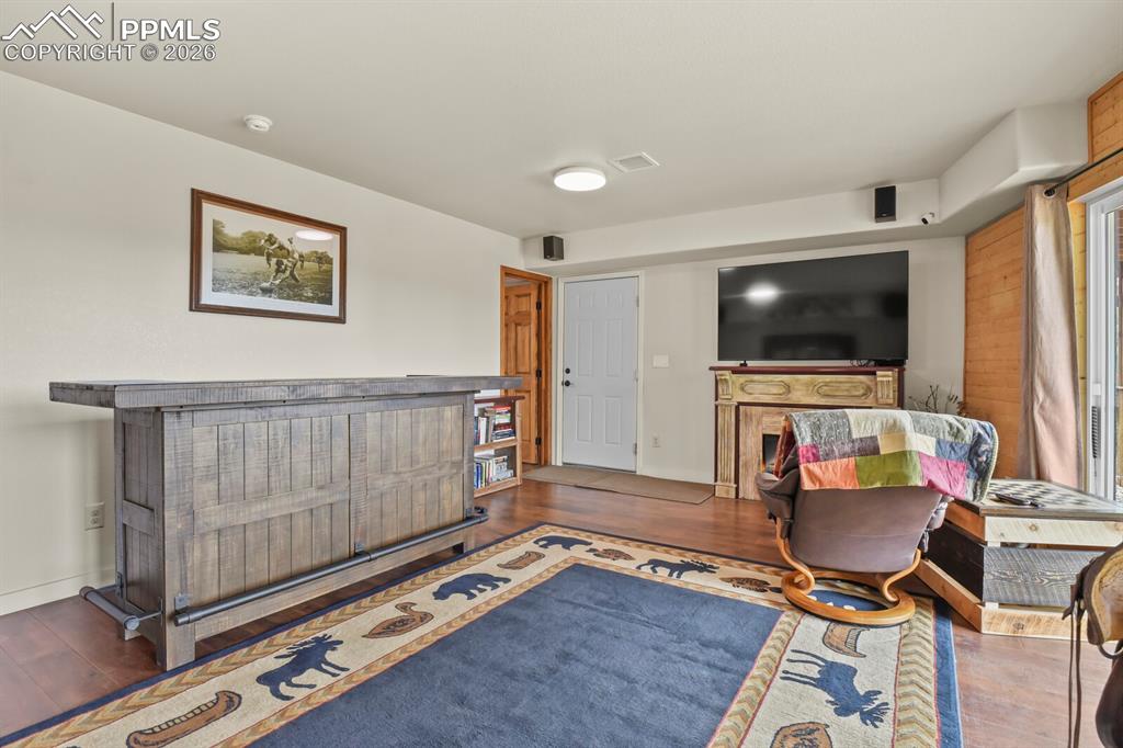 Image 21 of 41: Living area with dark wood-style floors