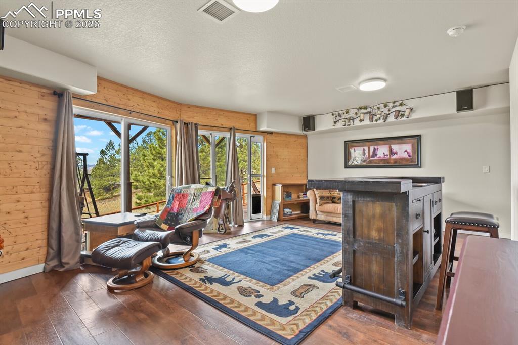 Image 22 of 41: Living room featuring dark wood-style floors and Walk out to Deck
