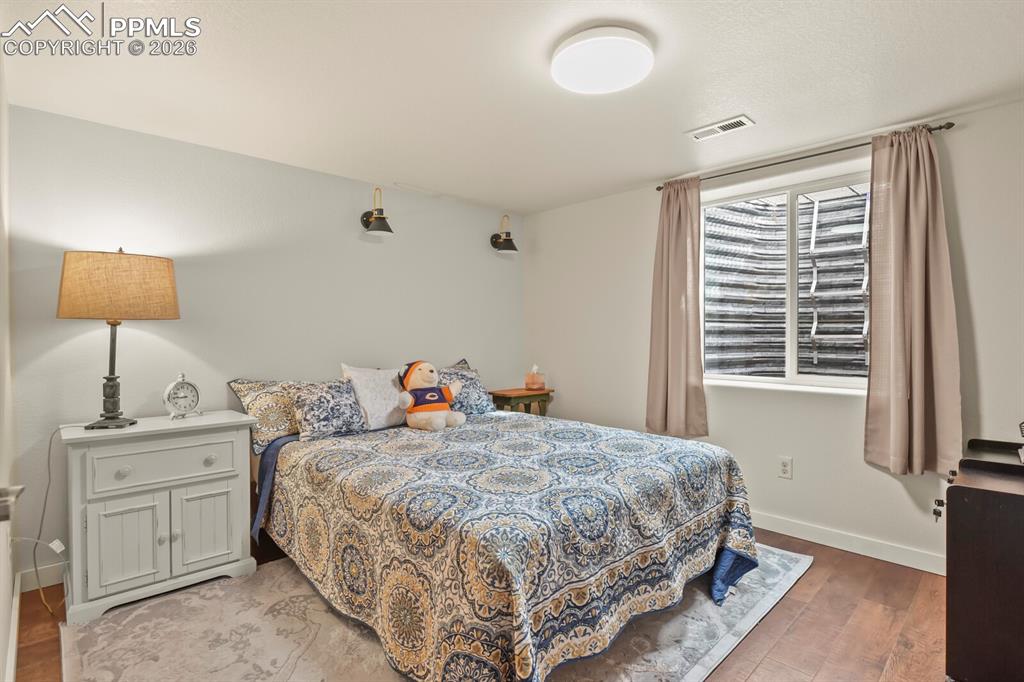 Image 23 of 41: Bedroom with wood-style flooring