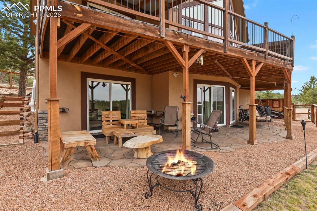 Image 28 of 41: View of patio / terrace featuring a deck and a fire pit