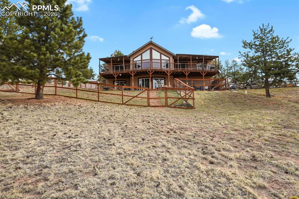 Image 30 of 41: Back of property with a deck
